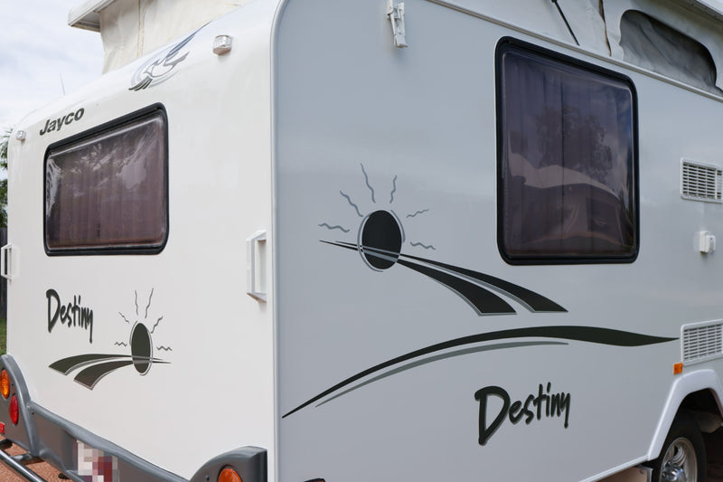 Close-up of a Jayco Destiny travel trailer with branding and design elements.