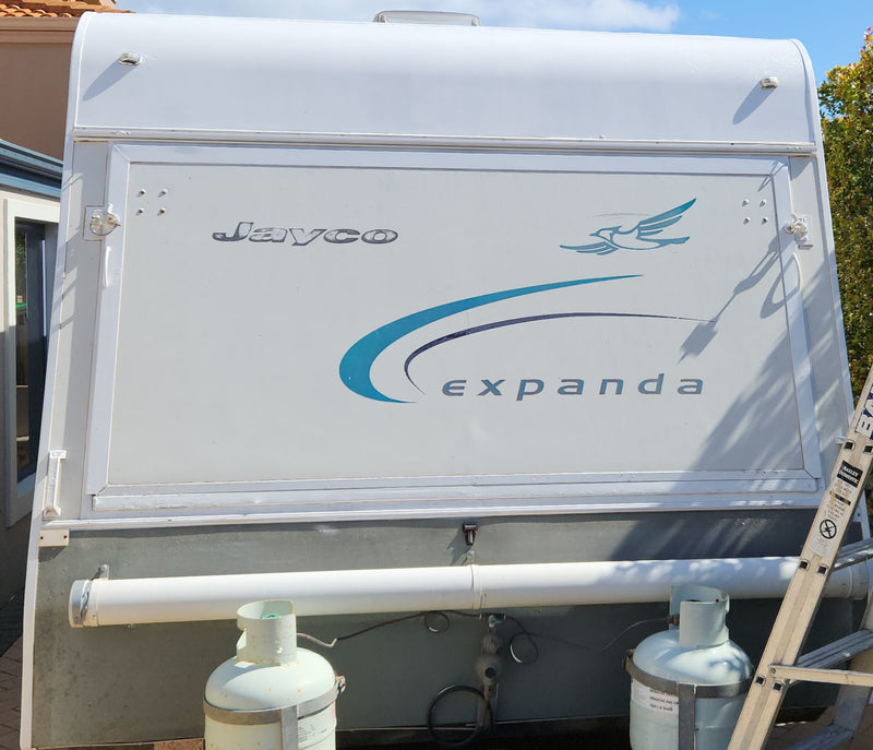 Jayco Expanda travel trailer with visible branding on a clear day.