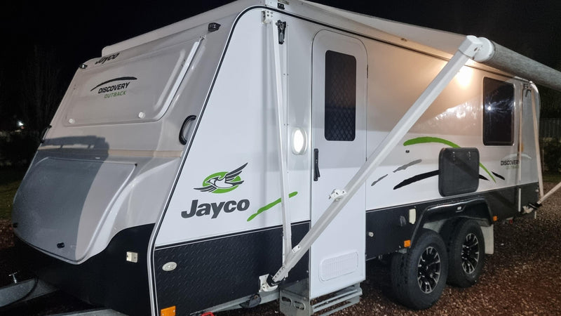 Jayco travel trailer parked outdoors at night